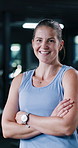 Arms crossed, face and laughing with woman in gym for commitment to exercise, vitality or workout. Confident, fitness and training with funny person in health club for challenge or dedication
