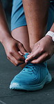 Fitness, sneakers and hands with lace in gym, workout preparation or indoor sports training for wellness. Getting ready, athlete or person tie shoes in health club, morning routine or start exercise