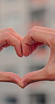 Outdoor, person and hands with heart sign for love, gratitude and express romance on holiday. Closeup, gesture and romantic symbol for kindness, positive icon and emoji with appreciation for vacation