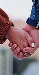 Love, couple or holding hands outdoor for care, connection or loyalty with partner on valentines day. Man, woman and support with romantic relationship, trust and commitment for marriage together