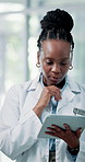 Typing, doctor and black woman on tablet in hospital for patient report, diagnosis and planning. Healthcare, clinic and person on digital tech for medical research, surgery schedule and thinking