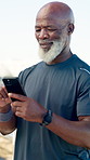 Texting, man and outdoor with smartphone, fitness and scroll on social media, smile or communication. Happy, mature person and browsing on website, wellness and networking with mobile after exercise