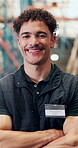 Happy, face of man and arms crossed in logistics for inventory management, shipping and about us. Bokeh, warehouse operator and laugh in storage facility for order fulfillment or distribution service