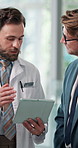 Doctors, men and tablet with review in lobby, insight and discussion with planning in clinic. People, hospital director and team with tech, app and checklist with report for healthcare services