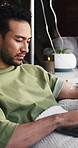 Laptop, iv infusion and man at clinic with relax for social media, research or reading blog. Technology, wellness and male person with computer for nutrition information with health at vitamin bar.