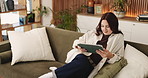 Woman, student and relax with tablet at house for research, education and university application. Female person, digital and reading for online enrollment, college course and admission requirements