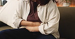 Woman, hands and sofa with stomach ache for menstruation, indigestion or gastrointestinal reflux. Female person, pain and belly with sore cramp for constipation, tummy bug or virus on couch in home