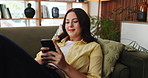 Phone, smile and social media with woman on sofa in living room of home for post or update. App, relax and typing on mobile with happy person in apartment for break, communication or me time