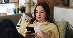 Phone, scrolling and social media with woman on sofa in living room of home for post or update. App, relax and search with person typing on mobile in apartment for break, communication or me time