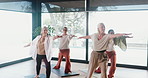 Yoga, senior women and exercise in class with warrior pose, stretching and holistic wellness. Yogi, elderly people and group practice with balance, health and fitness in active retirement in studio
