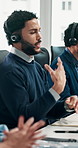 Computer, explain and headset with man in call center for feedback, problem solving or support. Communication, customer service and solution with agent at desk in office for assistance or help