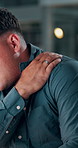 Shoulder pain, tired and night with business man in office for stress, burnout and deadline pressure. Fatigue, exhausted and overworked with person in agency for mental health, bokeh and injury