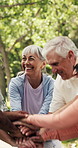 Teamwork, hands stack and mature people outdoor for fitness, motivation or celebration. Group, friends and huddle together for solidarity, community and partners with support in park for health goals