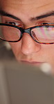 Laptop, reading and thinking with designer man in office for development or problem solving. Computer, glasses and solution with employee person in design workplace for online planning or research