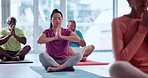 Woman, meditation and prayer hands at yoga class on floor with breathing exercise for wellness. People, holistic fitness and namaste for awareness on mat, eyes closed or mindfulness with group at gym