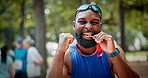 Man, medal and face with celebration for trail running competition in forest with fitness goals. Athlete, person and champion with fist pump, success or portrait for achievement with winning in woods