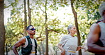 Marathon, people and running competition in forest for fitness challenge, sport event or wellness. Runners, group and race contest in nature for endurance trail, jogging stamina or cardio performance