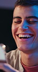 Night, funny and happy man with smartphone, internet and online reading for joke. Evening, mobile user and person with cellphone, laughing and digital app for comedy, meme and connection for humor