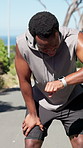 Fitness, black man and running with watch or break in nature for tracking workout or performance. Tired, male person or runner checking wristwatch with rest, recovery or app for health and wellness