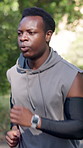 Black man, running or fitness with workout in nature for cardio exercise or physical training. Active, male person or runner jogging with breathing or motion for vitality, health and wellness in park