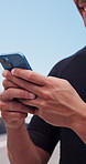 Phone, cyclist and hands of man outdoor with texting, networking or communication on mobile app. Technology, sports and athlete with cellphone for chatting, contact or social media with fitness.