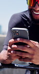 Cyclist, hands and man with phone in city for fitness app, track performance and cycling break. Happy, athlete and smartphone on bicycle outdoor for online ride map, exercise progress and cardio rest