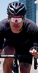 Cyclist, man and cycling on bike in city for cardio workout, endurance challenge and pace training. Sunglasses, athlete or riding bicycle in road for triathlon fitness, sports performance or wellness