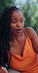 Relax, talking and chat with black woman outdoor for summer vacation, connection and conversation. Discussion, holiday resort and gossip with person in nature for communication and weekend break