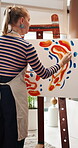 Painting, woman and canvas in home studio for creative project, visual expression and creation for craft. Passion, easel and artist with inspiration for activity, color and talent for abstract design