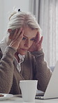 Mature, woman and stress with headache on laptop for project deadline, strain or pressure in home. Frustrated, female person or computer with migraine for fatigue, anxiety or mental health in house