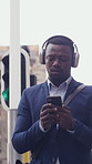 Businessman, walk and phone in city with headphones, streaming music and morning commute for job. Black person, journey and audio tech in urban town with online radio, social media or travel to work.