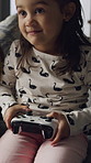 Happy girl, gamer and playing with controller on sofa for online entertainment in home. Child, kid or playful game with console remote for friendly challenge, match or esports on couch in house