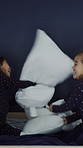 Sisters, children and pillow fight on bed with laugh for bonding, connection and love in family home. Girl, kids and happy with play, contest or relax with pyjamas for funny game in morning at house