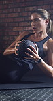 Fitness, woman and workout in gym with medicine ball, strength training and oblique twist for wellness. Active, person and core exercise in health club with equipment, balance and cardio challenge.