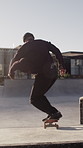 Man, action and trick with skateboard in city for training, jump and extreme sports from back. Professional skateboarder, person and leap for stunt at skatepark outdoor, exercise and performance