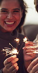 Outdoor, sparklers and face of happy couple with holiday,  anniversary trip and commitment celebration. Marriage, laughing and people with fireworks for romantic vacation, love and new year memory