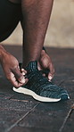 Fitness, preparation or hands outdoor with shoelace, getting ready or footwear safety in physical hobby. Exercise, secure or man with sneaker, sportswear check or injury prevention in training start.