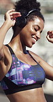 Dancing, sports and woman with headphones by beach with music for workout, training or challenge. Audio tech, fitness and female person listening to playlist for exercise, health or active by ocean.