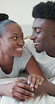 Happy, black couple and laughing with love on bed for funny joke, comfort or trust in home. Man, woman or relax with smile, embrace or care in bedroom for humor, comedy or bonding together in house