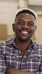 Carpenter, face and man with arms crossed, factory and pride with craftsmanship skills and creative. Furniture, manufacturing and black person with smile in workshop, happy and woodworking production