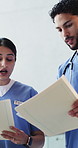 Doctor, documents and people with discussion, help and feedback for schedule. Advice, physician and nurses in clinic, conversation or paperwork for medical service, teamwork or healthcare information