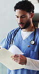 Documents, nurse and search with man in hospital for healthcare report, test results and research. Medical history, paperwork and reading with person in clinic for treatment records and folder