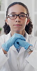 Doctor, gloves and face of woman in laboratory for vaccine engineering, healthcare expert and case study. Clinical trial, medical specialist and science with person for biochemist and research