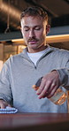 Restaurant, man and cleaning table with spray for hygiene maintenance, workflow and dust removal. Small business, owner and cloth to wipe counter for coffee shop compliance, safety policy or bacteria
