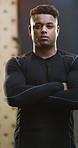 Crossed arms, serious and face of man in gym with confidence for workout, active or training. Fitness, athlete and portrait of male person with pride for exercise, wellness or health in sports center