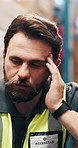 Supply chain, headache and man in warehouse, stress and anxiety for backlog, export schedule and inspection. Person, pain and employee in factory, migraine or pressure for logistics, tired or burnout