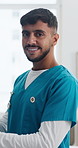 Man, nurse and face at clinic with smile for career for pride, confidence and medical services. Person, caregiver and happy in portrait for telehealth, tech or application at hospital in Colombia