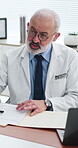 Hospital, doctor and man with patient, talking or medical results for illness, checkup and paperwork. Clinic, healthcare worker and mature person with report for diagnosis, discussion and appointment