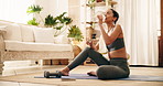 Drinking water, fitness and yoga with woman in living room of home for health or wellness. Balance, exercise and hydration with thirsty yogi person on floor of apartment for holistic routine break