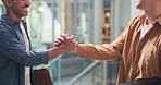 Businessmen, meeting or greeting with handshake for partnership, introduction or deal in office. Male people, employees or colleagues with smile or handshake for friendship or teamwork in workplace